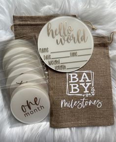 the baby announcement is displayed on top of a brown bag with white buttons and tags