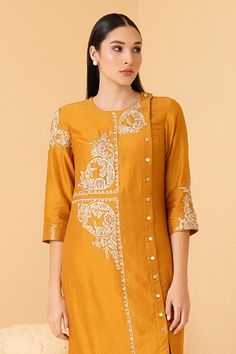 Mustard tunic with zari, sequin, pearl embroidery in floral pattern. Paired with pant.
Components: 2
Pattern: Embroidery
Type Of Work: Zari, sequin, pearl, floral
Neckline: Round
Sleeve Type: Three quarter
Fabric: Pure Chanderi
Color: Yellow
Other Details: 
Front button detailing
Attached lining
Length:
Sleeves: 18 inches
Weight: 1.5 kgs
Occasion: Mehendi and Haldi - Aza Fashions Pearl Embroidery, Pattern Embroidery, Embroidered Tunic, Pant Set, Set For Women, Aza Fashion, Fashion Set, Sleeve Type, Three Quarter