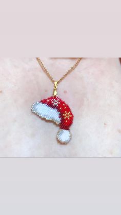 a red and white knitted christmas stocking ornament on a woman's chest