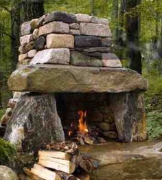 an outdoor fireplace made out of rocks and logs