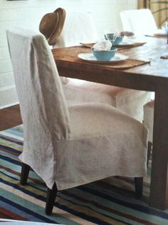 a dining room table with two chairs and a bowl on top of the table in front of it