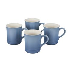 four blue coffee mugs sitting next to each other