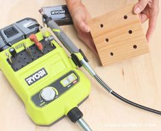 a person is working on a piece of wood with a drill and screwdriver