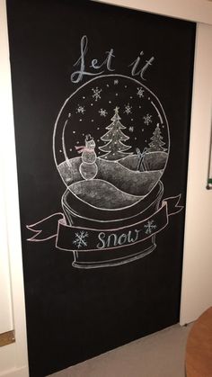 a chalk board with a snow globe drawn on it