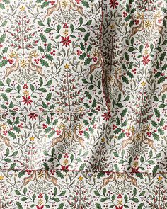 the fabric is decorated with holly and berries