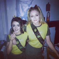 two young women dressed in green and yellow t - shirts posing for a photo together