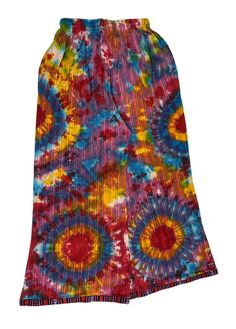 Crafted from soft and breathable cotton fabric, these pants offer a lightweight, airy feel ideal for balmy weather. Embracing the palazzo style, they boast wide legs that cascade gracefully, evoking a relaxed, bohemian aesthetic. Adorned with tie-dye and Aztec patterns along the bottom hem and pockets, they blend colors harmoniously, resulting in a captivating design. The loose-fitting silhouette ensures unrestricted movement and a breezy sensation. Whether you're out for a casual excursion, imm Summer Cotton Harem Pants, Multicolor Cotton Wide Leg Hippie Pants, Hippie Multicolor Wide Leg Pants For Festivals, Relaxed Fit Long Skirt For Beach, Festival Cotton Wide Leg Pants With Elastic Waistband, Flowy Cotton Beach Bottoms, Flowy Cotton Bottoms For Beach, Flowy Cotton Bottoms For The Beach, Summer Bohemian Wide Leg Pants In Relaxed Fit