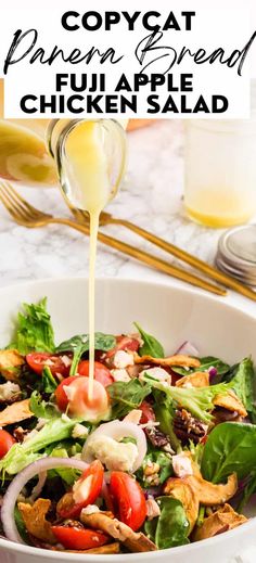 a white bowl filled with salad and dressing being drizzled on top of it