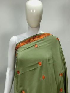 Get back in style with this Irresistible, Sozni Hand Embroidered Pickle Green Kashmiri Saree and let your Ethnic Fashion flow on any occasion be it a party or a wedding. - - - - - - - - - - - - - - - - - - - -  Product Details - Condition: Brand New (made to order) - Style: Saree Dress - Embroidery: Sozni Hand Embroidery - Base Colour: Pickle Green - Embroidery Colour: Multi-Colour - Care Instructions: Dry Clean Only F A B R I C Saree:  Pure Crepe  Blouse: Pure Crepe F I N I S H - Unstitched You Traditional Silk Embroidered Dress With Traditional Drape, Traditional Silk Embroidered Dress With Drape, Traditional Green Dress With Chikankari Embroidery, Green Embroidered Dress With Traditional Drape, Traditional Silk Dress With Chikankari Embroidery, Green Silk Fabric With Chikankari Embroidery, Traditional Silk Embroidered Dress, Transitional Embroidered Green Saree, Green Bollywood Embroidered Dress