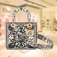 The Lady Dior My ABCDior bag embodies the Maison's vision of elegance and beauty. Crafted from calfskin with a beaded Dior Bandana motif in black and white, this timelessly elegant creation evokes the Seville-inspired style of the collection. D.I.O.R. metal charms with a bright gold finish draw the eye to the silhouette. The small, unique design can be customized with badges on the shoulder strap and can be carried by hand or as a shoulder bag. Wide, adjustable and customizable shoulder strap with three badges. Shoulder strap holds a total of six badges. Zippered compartment inside Can be combined with different embroidered shoulder straps Protective pouch included Made in ItalyCOMPOSITIONDior bandana with print and pearl embroideryProduct code:M0538OEAI_M993SIZE GUIDE WIDTH×HEIGHT×DEPTH：2 Dior Bandana, Lady Dior My Abcdior Bag, Wallet Chains, Dior And I, Pearl Embroidery, Small Lady, Metal Charms, Handbag Wallet, Bright Gold