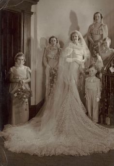 an old black and white photo of a bride with her family