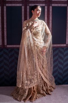 a woman in a dress and veil poses for the camera with her hands on her hips