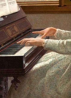 a woman sitting at a piano with her hands on the keys and an open book behind her