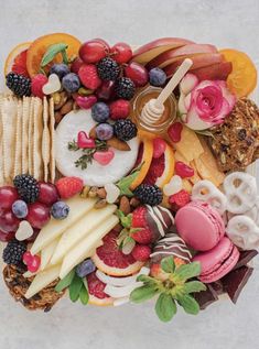 an assortment of fruits and pastries arranged on top of each other