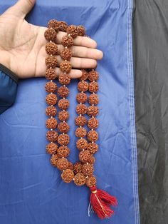 Rudraksha Origin:- Nepali Rudraksha (Premium Quality) 5 Face/Mukhi Rudraksha Pathri Mala (Premium quality) Beads - 54 + 1 Wearing Each beads Size - 19 - 20 MM (Apx.) Traditional Beaded Necklaces With Round Beads For Festivals, Traditional Round Beaded Necklaces For Festivals, Traditional Beaded Necklaces For Rituals And Festivals, Beaded Tilla Necklaces For Puja And Diwali, Festive Rituals Mala With Pallu, Traditional Beaded Necklaces With Latkans For Diwali, Traditional Hand-strung Beaded Necklaces For Festivals, Festive Beaded Necklace With Latkans And Round Beads, Temple Jewelry Mala With Pallu For Puja