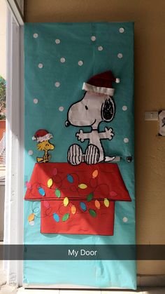 a door decorated with a snoopy christmas decoration