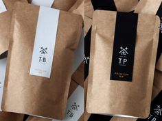 there are many brown bags with black and white designs on them, one has a tag that says tp