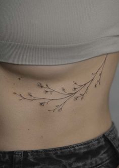 a woman's stomach with small flowers on it