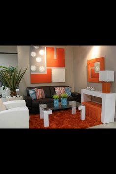 an orange and white living room with modern furniture