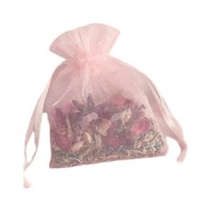 a bag filled with lots of flowers on top of a white surface