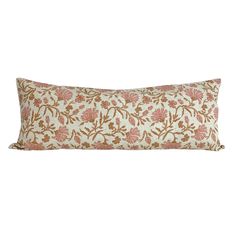 an orange and white floral pillow on a white background with pink flowers in the center