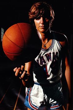 a man holding a basketball in his right hand