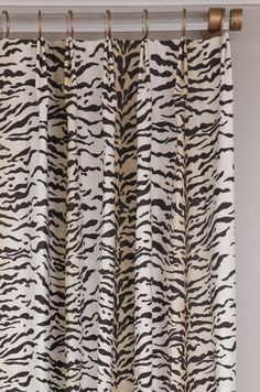 a zebra print curtain hanging in front of a window