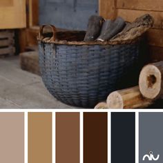 a basket filled with logs sitting on top of a wooden floor next to a wall