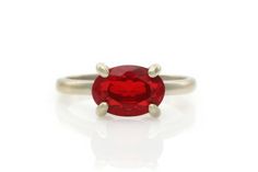 A delicately handmade red ring with a vibrant Ruby stone set in a horizontal ring design. This unique ring is finished with a gleaming high polish claw setting. An excellent choice for an engagement ring, anniversary ring or gift ring for occasions. ☛ 𝒜𝐵𝒞 - Add Engraving - https://etsy.me/3CLxYPZ ☛ Ring size - Select the size you would like from the drop down menu ♥ Gemstone Type - Ruby (Lab Created) ♥ Gemstone Size - 7x10mm ♥ Gemstone Cut - Oval ♥ Metal Type (Main Photo) - 925 Sterling Silve Ruby Ring Engagement, Unique Ruby Rings, Ruby Ring Silver, White Gold Ruby Ring, Gold Ruby Ring, July Birthstone Ring, Red Ring, Fancy Gifts, Claw Setting