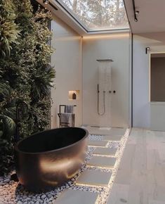 a bath tub sitting in the middle of a bathroom next to a shower and window