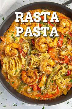 a pan filled with pasta and shrimp on top of a table