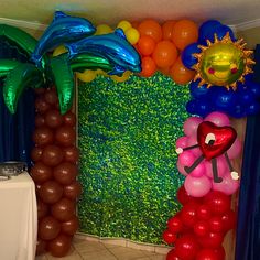 balloon decorations in the shape of animals and palm trees are on display at a party