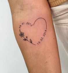 a woman's arm with a heart shaped tattoo on it