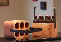 a wooden block with six bottles in it on a table next to a metal holder