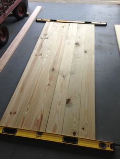 some wood planks are laying on top of the floor next to a forklift