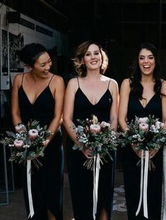 the bridesmaids are all wearing black dresses and holding bouquets in their hands