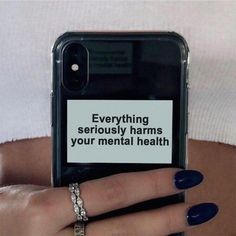 a woman holding her cell phone with the text social media seriously harms your mental health