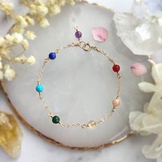 ✨ Seven Chakra Gemstone Bracelet with 14K Gold Filled, Rose Gold Filled, Sterling Silver Delicate Layering Bracelet, Rainbow Stone Bracelet ✨• Handmade in your preferred size with genuine gemstone beads. All metal parts are made with 14K Gold Filled, Rose Gold Filled, or 925 Sterling Silver.• Gemstone size: 4 mm• Seven gemstones representing the 7 energy points in your body or "chakra". It is well believed in the spiritual world that keeping these 7 points well-balanced is the key to a healthy b Dainty Yellow Gold Bracelets With Gemstone Beads, Dainty Yellow Gold Bracelet With Gemstone Beads, Gold Multi-stone Bracelet As Gift, Multi-stone Round Gold Bracelet As Gift, Round Multi-stone Gold Bracelet As Gift, Dainty Gemstone 14k Gold Filled Bracelets, 14k Gold-filled Yellow Gold Bracelets With Birthstone, 14k Gold Filled Yellow Gold Bracelets With Birthstone, 14k Yellow Gold Filled Birthstone Bracelets