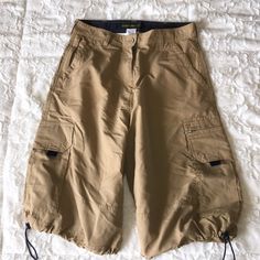 Tan Cargo Hiking Shorts. Drawstring Legs Large Cargo Side Pockets. Belted Waist. Waist Measures 15 "Across. 23" Length. Mean Girls Costume, Baggy Cargo Shorts, Knee Shorts, Khaki Cargo Shorts, Tan Shorts, Cargo Khaki, Cargo Short, Group 1, Hiking Shorts