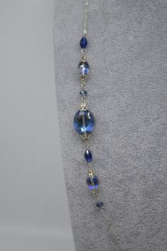 Necklace measures 27 inches long and features sapphire blue Austrian crystal beads. Chain is stainless steel as well the clasp. It can be dressed up or down and adds a fun pop of color and sparkle to your outfit! The length would be perfect to pair with a high collar shirt or sweater, not too long or too short. Find my shop here: https://www.etsy.com/shop/rhinestonerain?ref=seller-platform-mcnav Other necklaces like this one here: https://www.etsy.com/shop/rhinestonerain?ref=seller-platform-mcna Blue Metal Crystal Necklaces For Jewelry Making, Blue Crystal Necklaces For Jewelry Making, Elegant Blue Wire Wrapped Beaded Necklaces, Elegant Blue Wire Wrapped Beaded Necklace, Elegant Glass Wire Wrapped Necklaces, Blue Metal Jewelry With Faceted Beads, Blue Long Glass Necklace, Blue Glass Beaded Chain Jewelry, Blue Czech Glass Necklaces With Wire Wrapped Detail