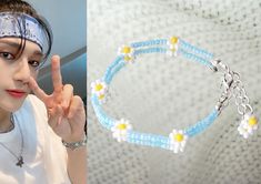 a woman wearing a headband and making the peace sign with her hand next to a blue beaded bracelet