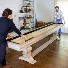 two men playing a game of shuffle board