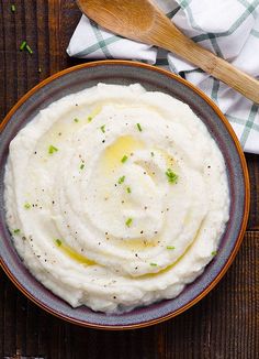 a bowl of mashed potatoes on a wooden table