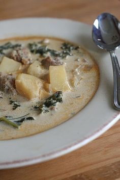 a white plate topped with food and a spoon