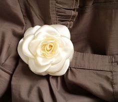 "Beautiful, delicate satin camellia flower with burgundy red /or other colour/ silk /satin/, perfect for wedding and parties. This flower brooch is the perfect addition to your outfit. It looks stunning on hats, jackets, dresses, scarfs, purses and clutches alike. Size: approx. /shown in picture/ 3\" (~8.5 cm) in diameter. If you need a flower of a different colour, or more than one flower, let me know! To see more flower brooches and hair accessories, just click the link: https://www.etsy.com/s Elegant Rosette Brooches As A Gift, Elegant Rosette Wedding Brooches, Elegant Rose Brooch With Handmade Flowers, Elegant Rose Brooches With Handmade Flowers, White Corsage, Brooch Fabric, White Camellia, Wedding Brooches, One Flower