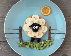 a plate topped with bananas, kiwis and an orange slice on top of it