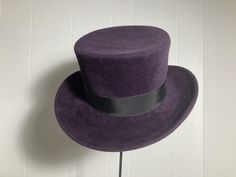 "Top Hat / Purple Fur Felt Hand-blocked and hand stitched by me Welted brim edge with invisible stitching to hold it in place  Size: L (58cm) 23 3/4\" circumference Height: 11.5 cm / 4.5\" tall* Brim (flared, lower part of the hat): 4.5cm wide Top of the crown: 62cm circumference Materials: fur felt, grosgrain ribbon *Up to 6\" for custom order @ extra charge Custom orders turnaround from 1 to 3 weeks depending on material availability. Please feel free to contact me." Fitted Purple Wide Brim Top Hat, Winter Top Hat With Flat Brim, Winter Fitted Top Hat With Flat Brim, Fitted Winter Top Hat With Flat Brim, Fitted Purple Hat With Short Brim, Purple Fitted Top Hat With Curved Brim, High Crown Fur Felt Fedora For Winter, Winter High Crown Fur Felt Fedora, Winter Fur Felt Fitted Hats