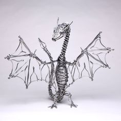 a metal dragon sculpture sitting on top of a table