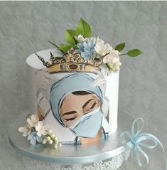 there is a cake decorated with an image of a woman wearing a surgical mask and flowers