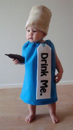 a baby wearing a blue dress and hat